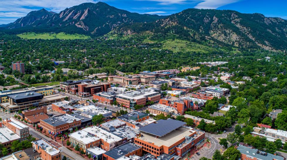 Downtown Boulder with the Flatiron mountains rising behind Pearl Street